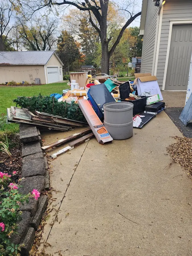 Dumpster being loaded with debris for Residential Dumpster Rental in Garner